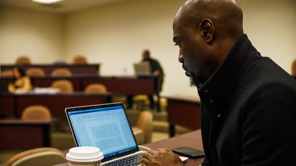 A student learning at his laptop in class.